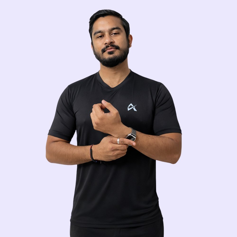 A man in a black V-neck T-shirt stands confidently, exuding a casual and stylish appearance.