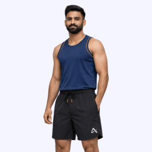 A man dressed in a tank top and black running shorts is ready for a workout.