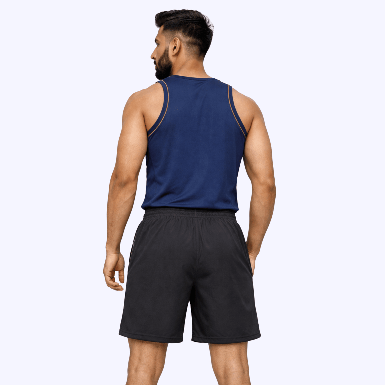 A man wearing a blue tank top and black running shorts, exuding a sporty and stylish vibe.