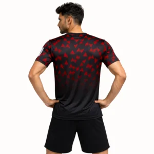 Back view of a man in a black Olympic drifit t-shirt featuring red triangles on the shoulders and upper back.