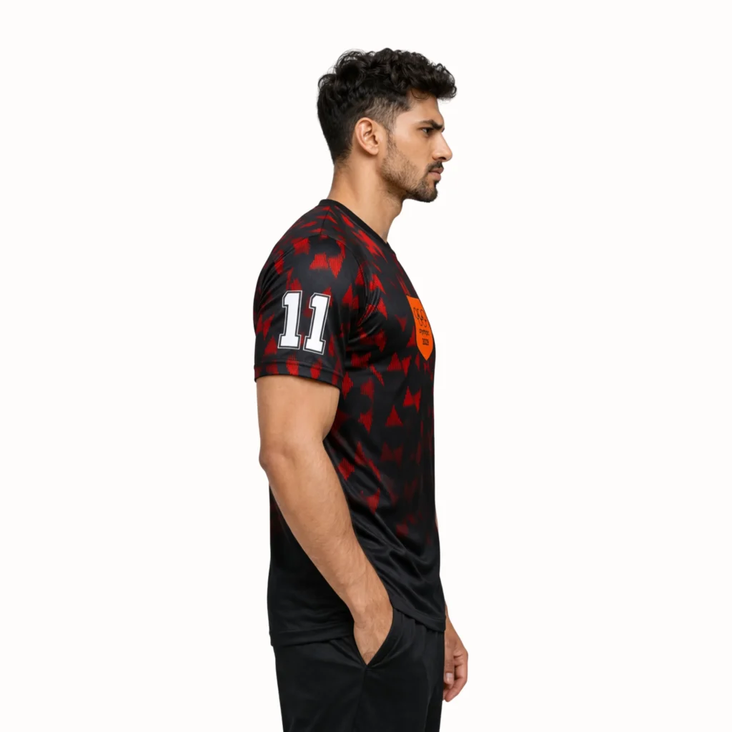 Man's side wearing a black and red Olympic Dri-FIT soccer jersey, highlighting the sporty style and color combination.